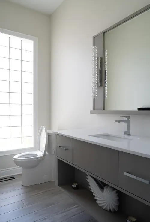 Bright white bathroom with grey and silver accents and clean lines