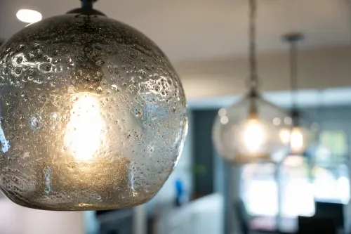 Close up of hanging pendant lights overtop kitchen island