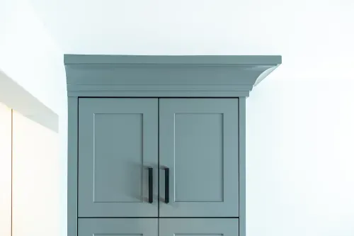 Close up of teal kitchen cabinetry along upper wall