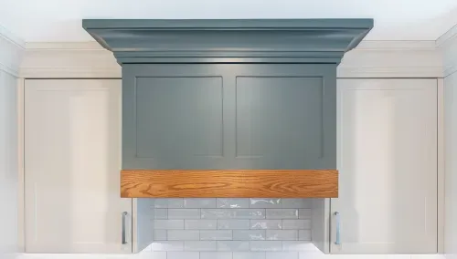 Detail shot of kitchen range hood and cabinetry