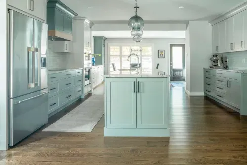 Side view of kitchen showcasing long open kitchen space with natural light and hardwood flooring