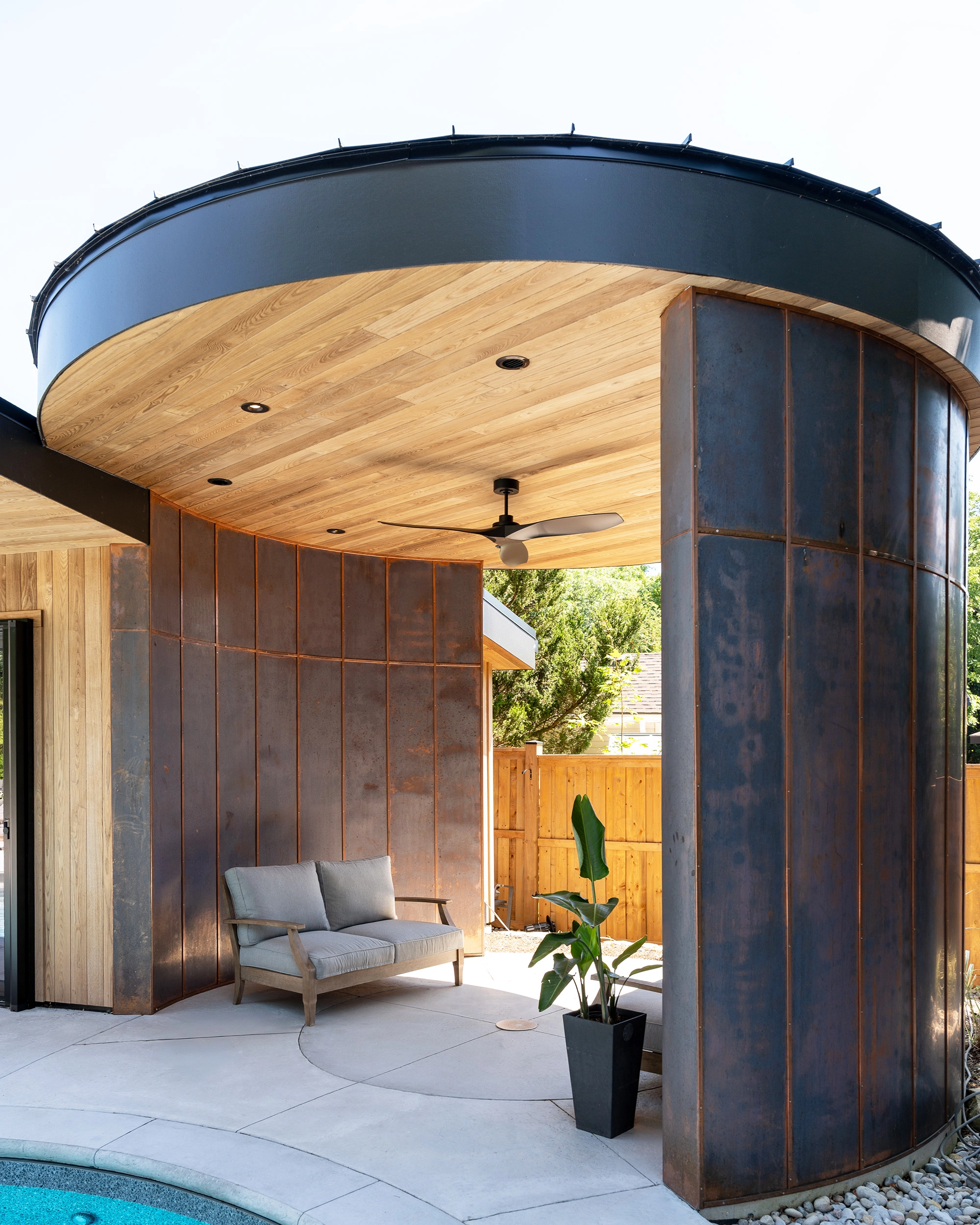 Detail shot of shaded outdoor seating area with copper and wooden architectural details