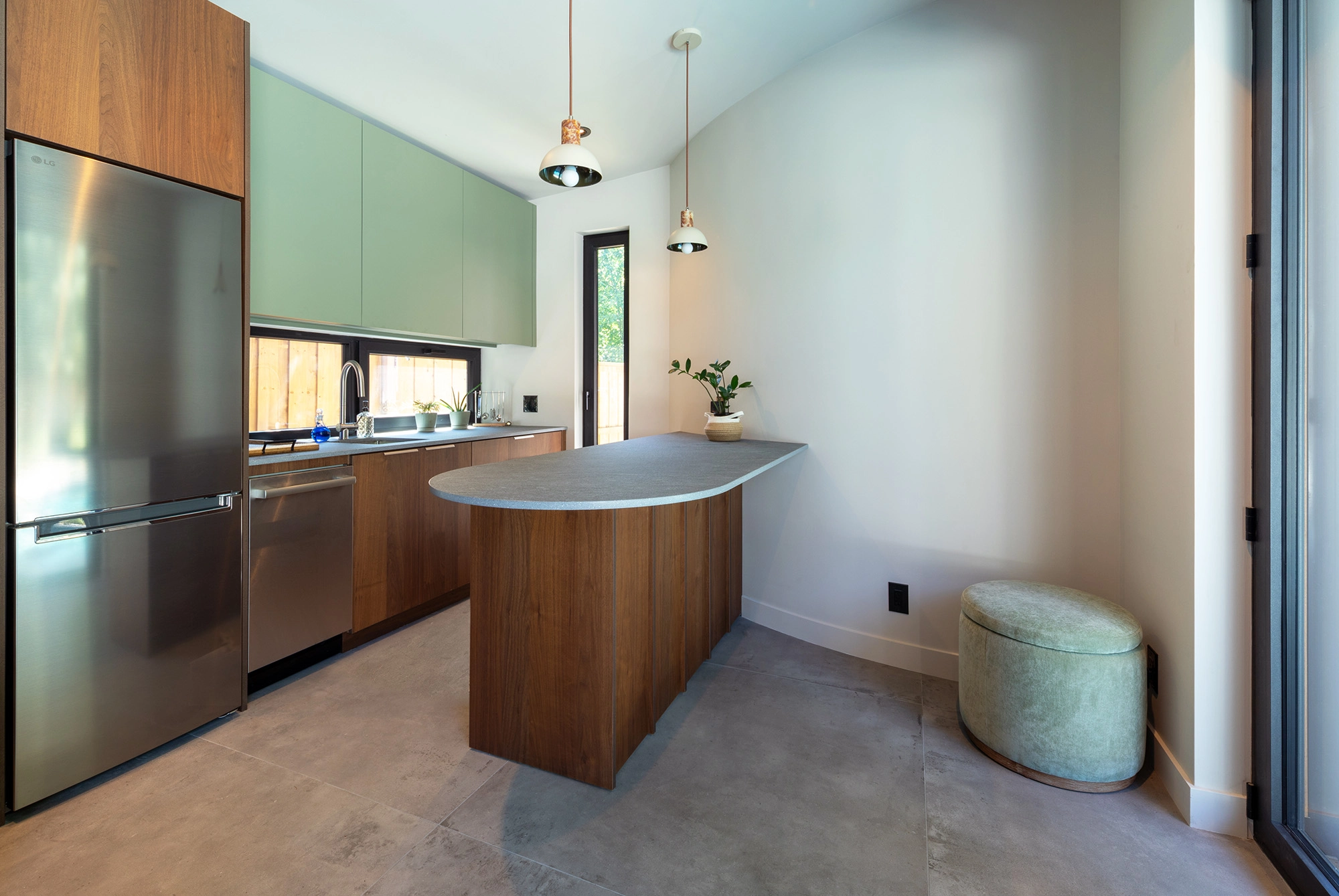 View of kitchenette space with modern cabinetry, kitchen island, and pendant lighting