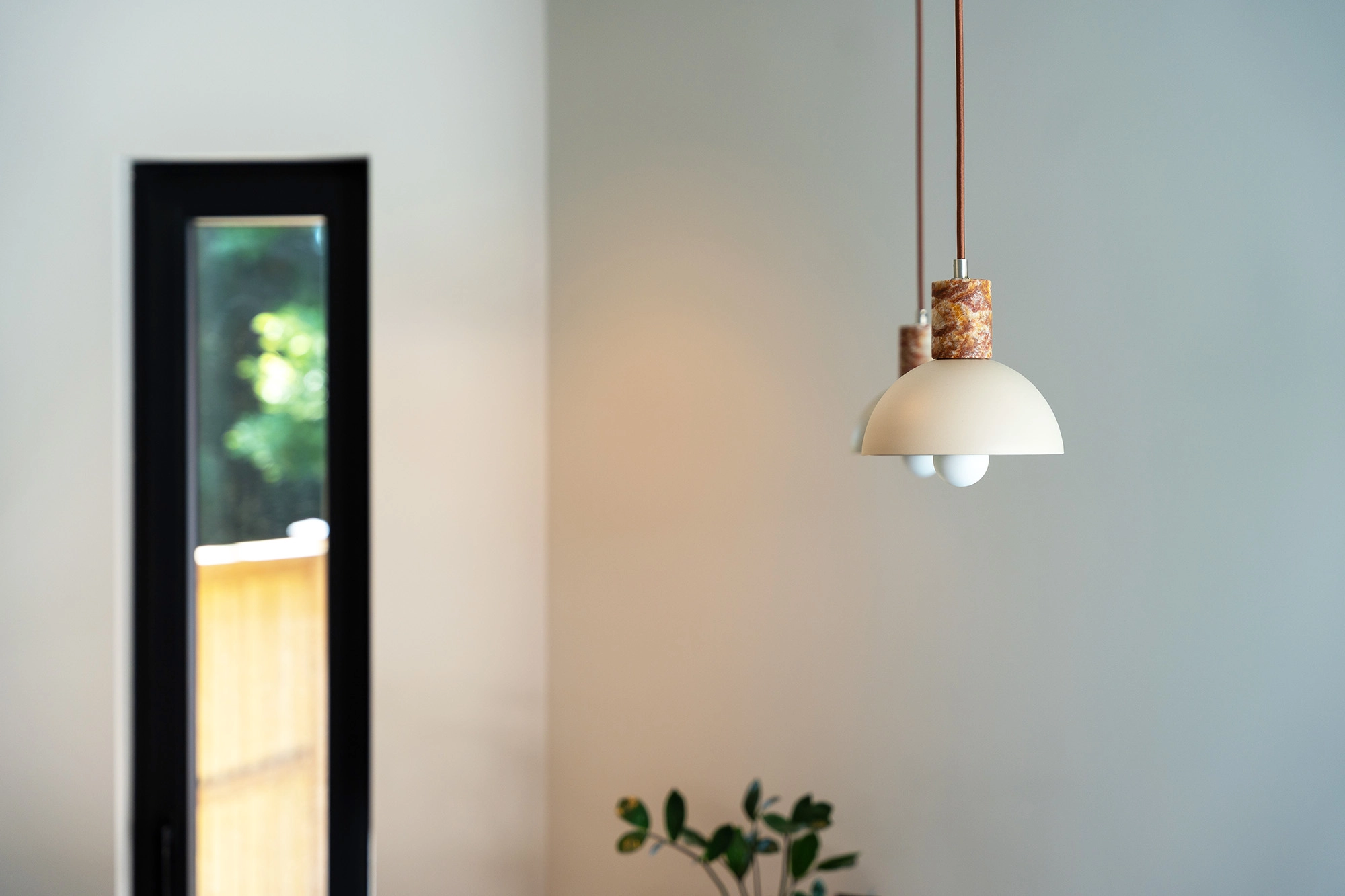 Detail shot of pendant lighting hanging above kitchenette island countertop