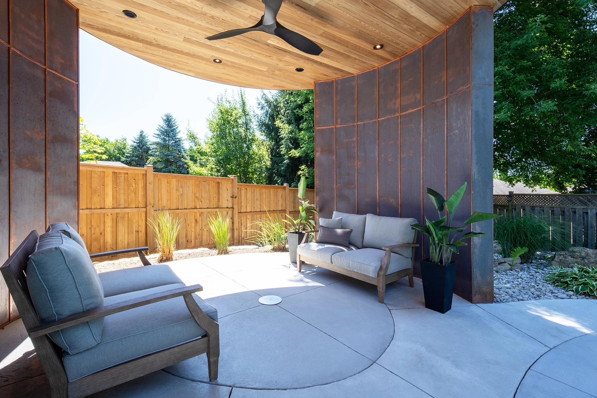 Patio furniture arranged under shade structure for open air rotunda