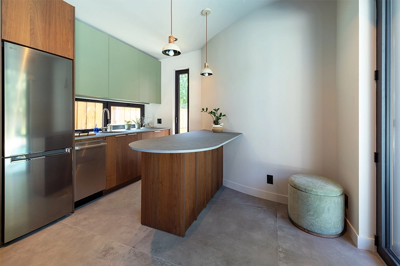 View of kitchenette space with modern cabinetry, kitchen island, and pendant lighting