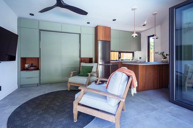 Poolhouse sitting area with kitchenette in background