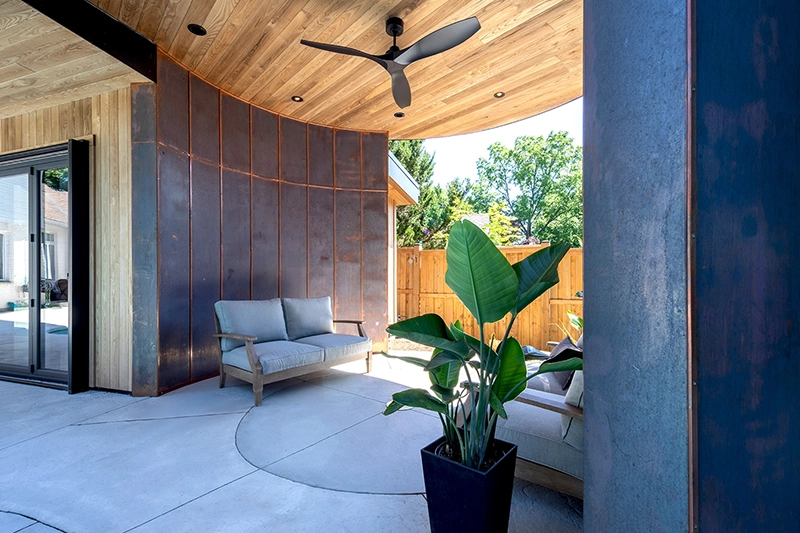 Detail shot of shaded outdoor seating area with copper and wooden architectural details