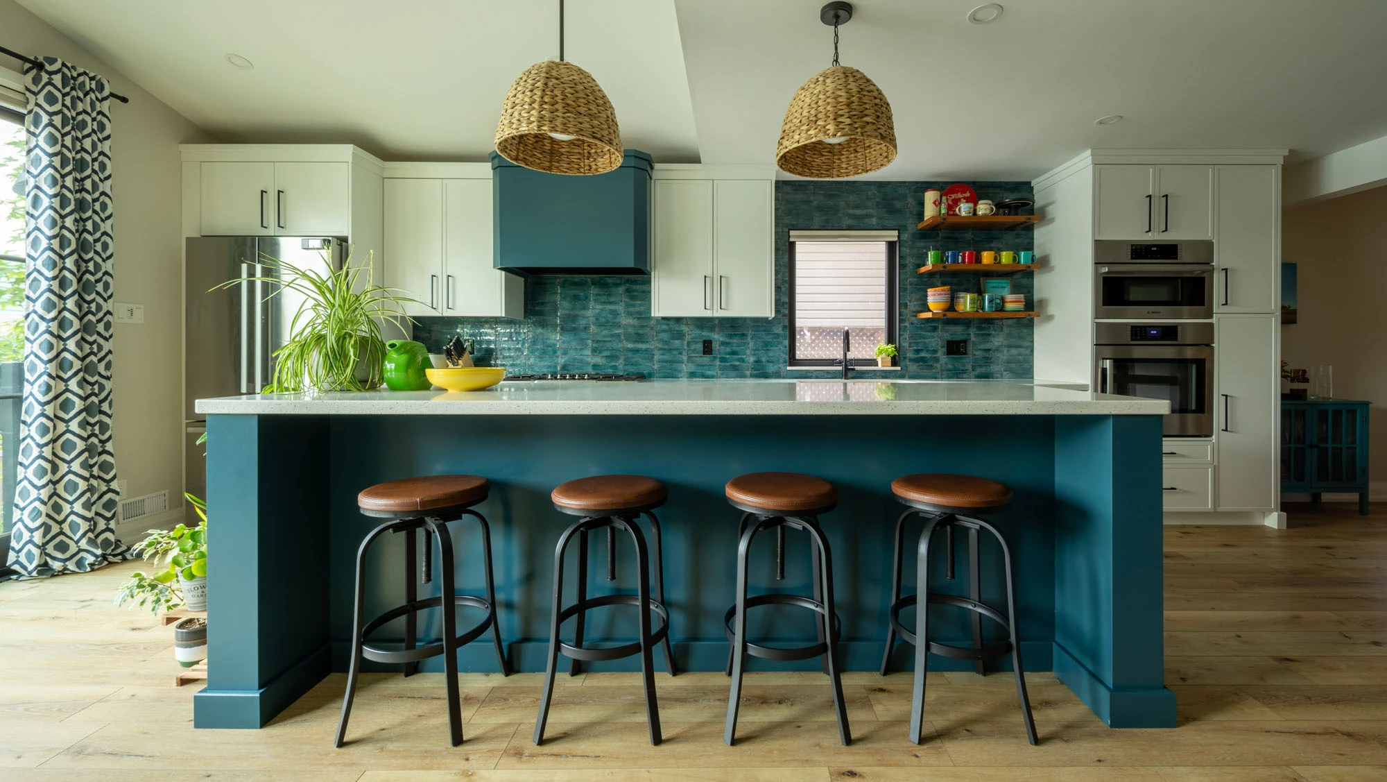 Bright kitchen with blue cabinetry and colourful dishes displayed on shelving