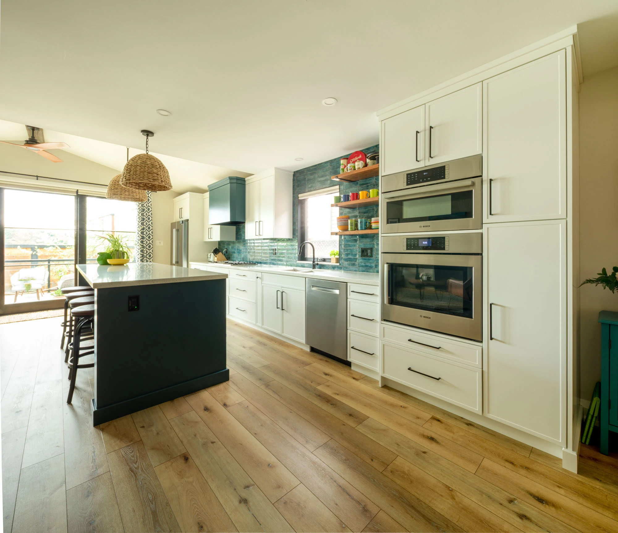 Kitchen space with white cabinetry and hardwood floors