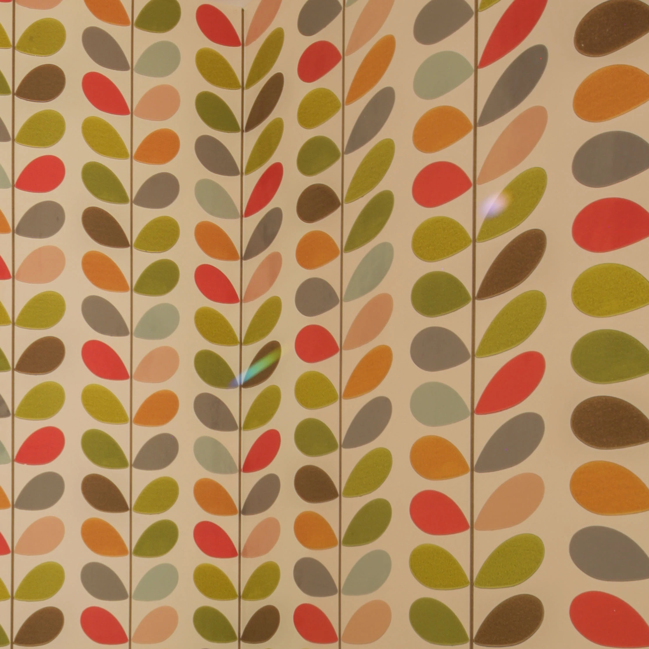 Detail shot of brightly coloured patterned wallpaper applied to powder room