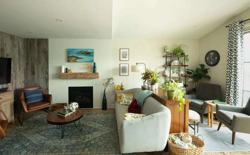 Living room space with large seating area, decorated with colourful accents and plants