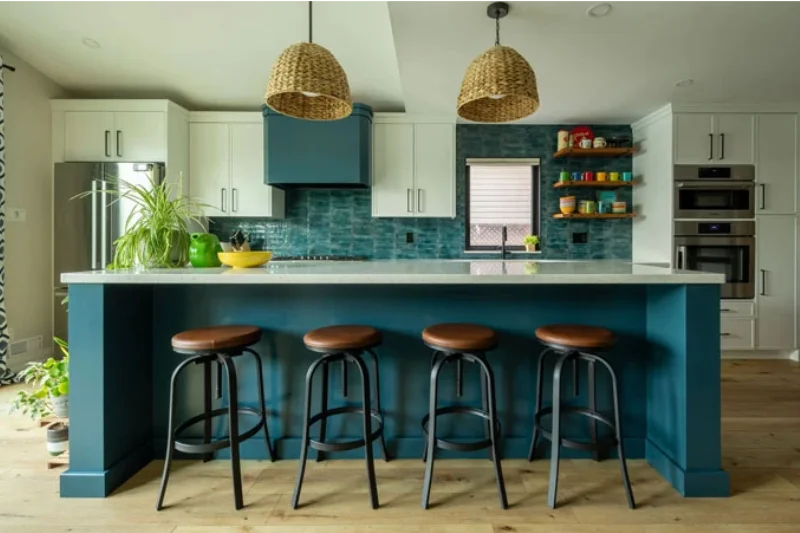 Bright blue kitchen island with white and blue kitchen cabinetry in background