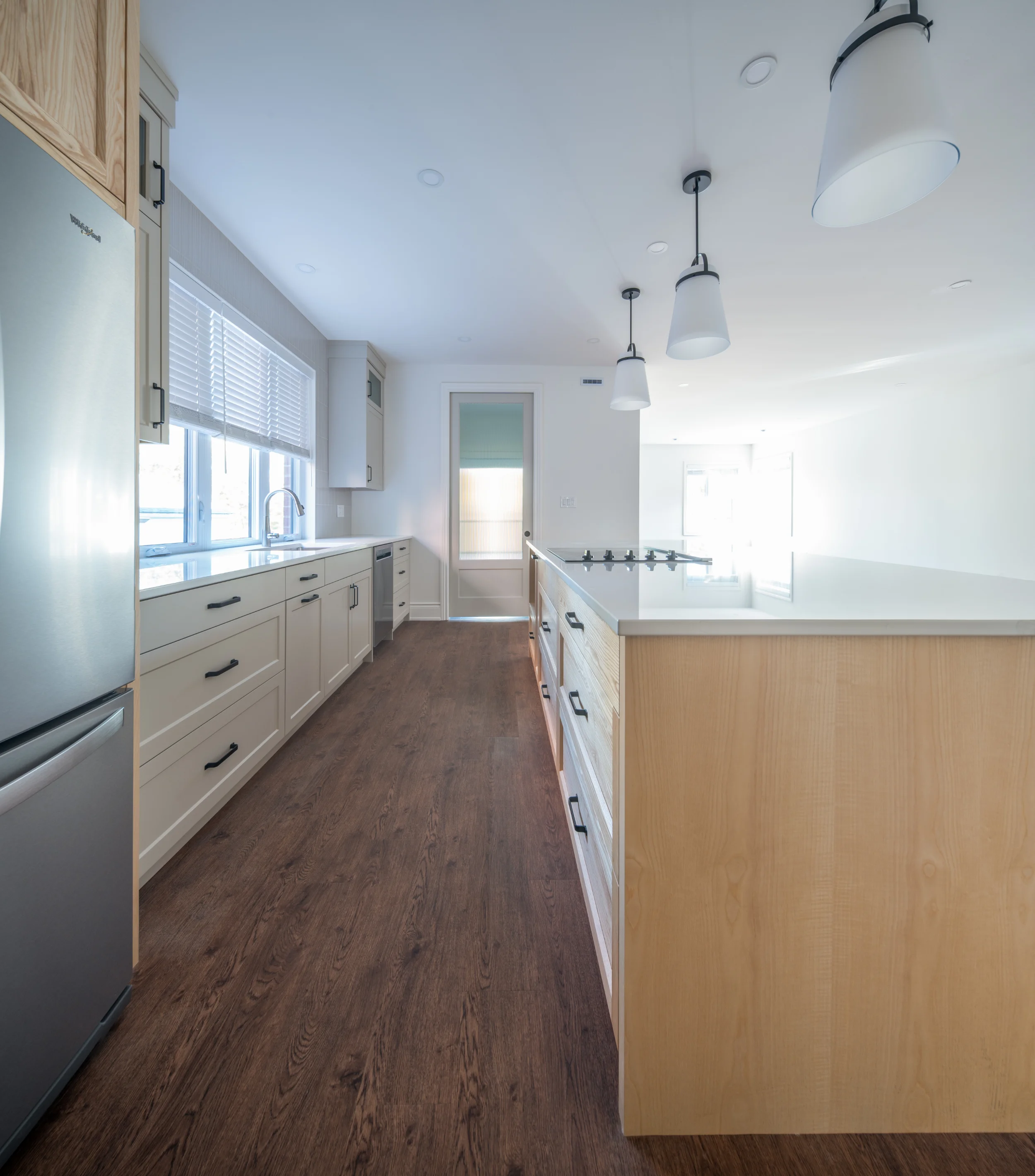 a galley look at the kitchen with cupboards
