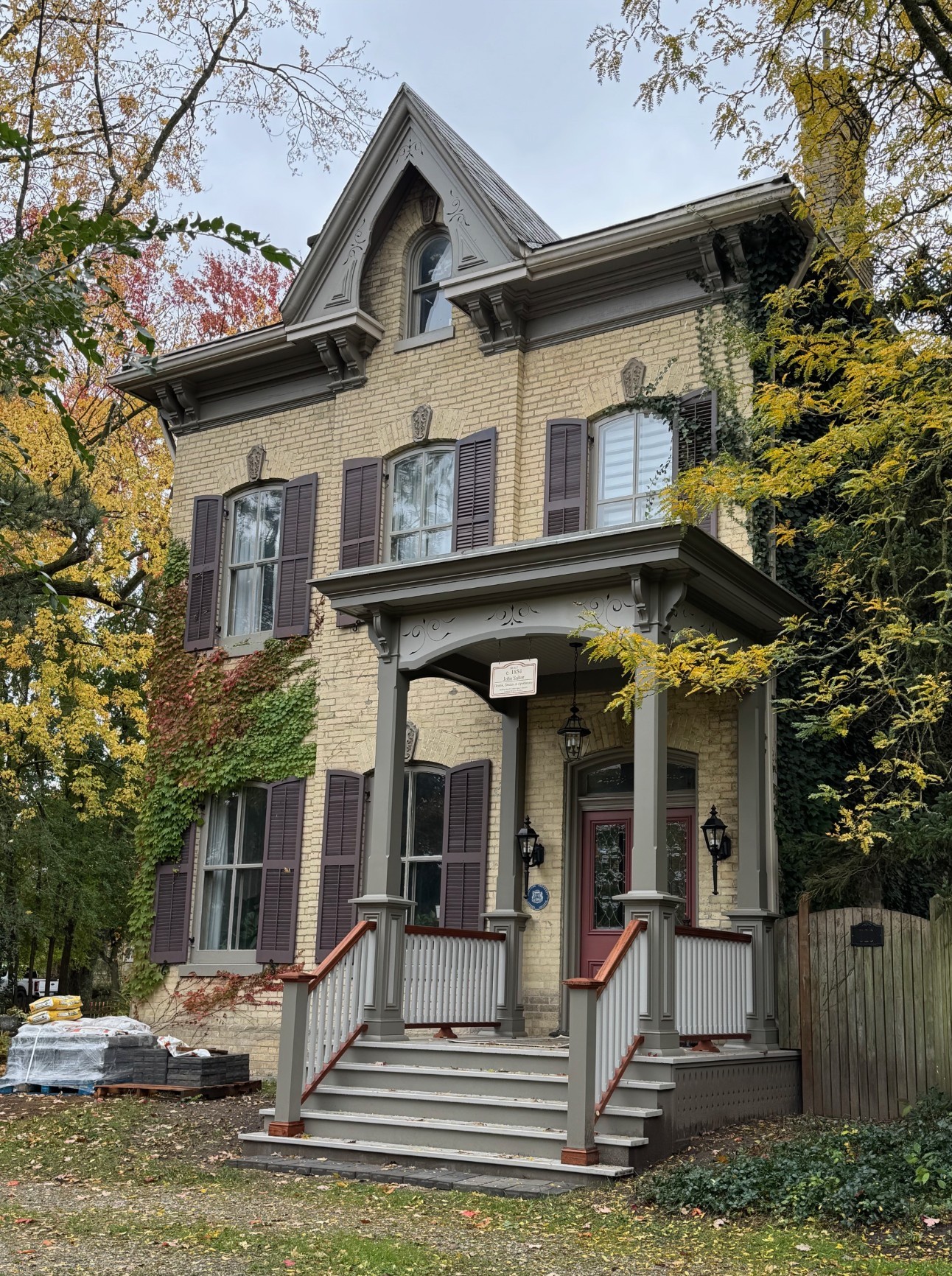 full front of heritage home with classic architecture design and large front deck and stairs
