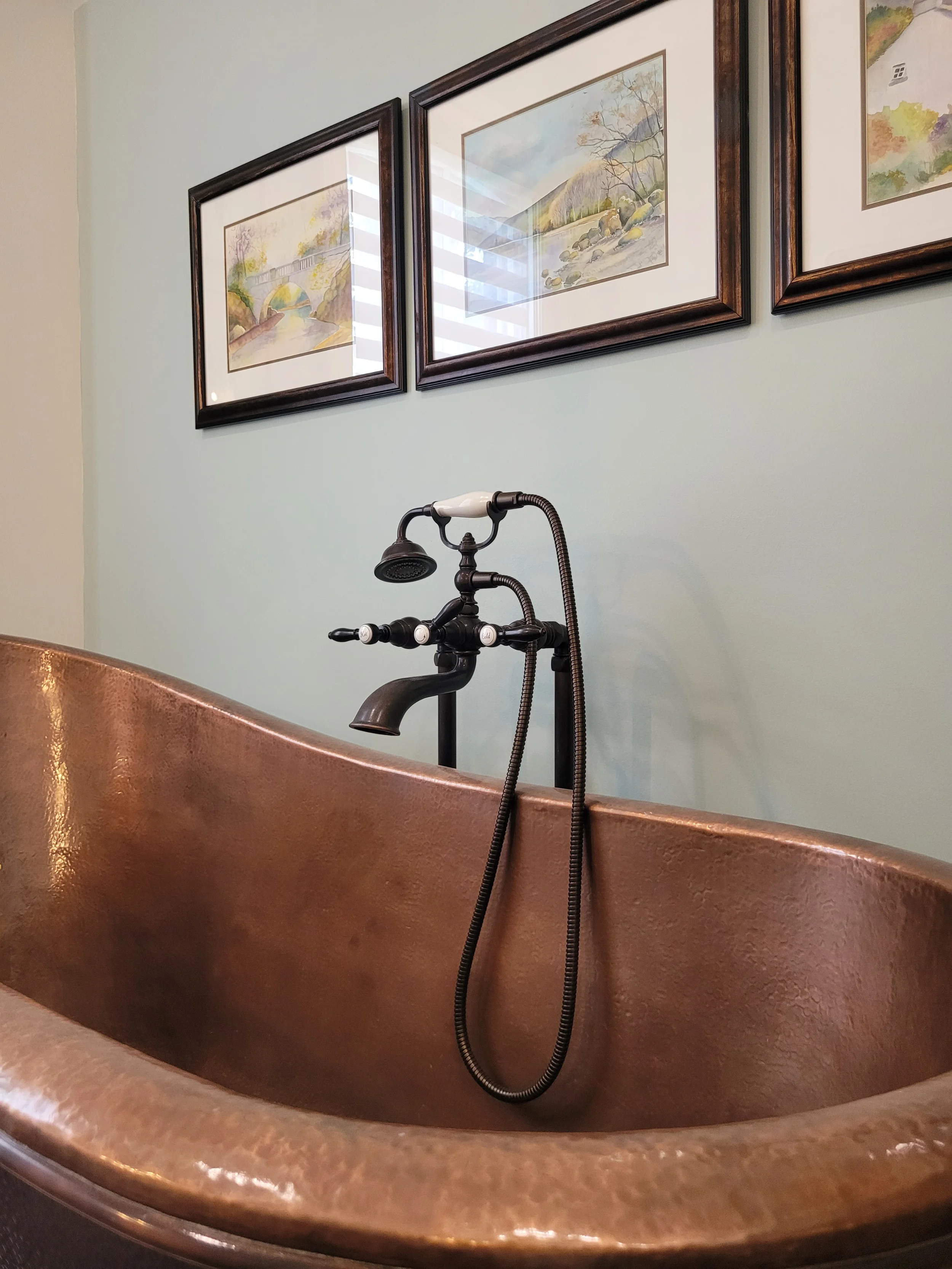 a copper heritage tub with heritage faucets