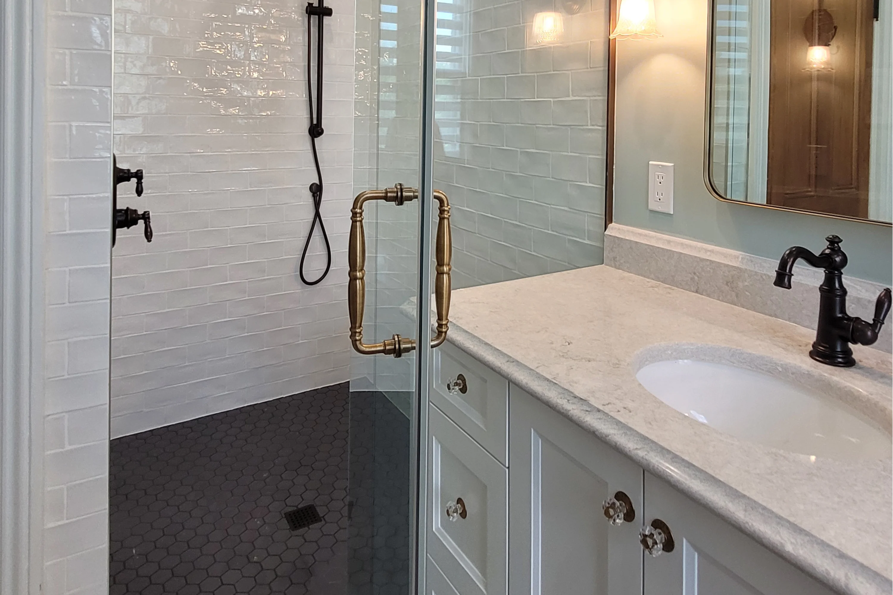 heritage bathroom with shower stall with glass walls, and a classic sink with cupboards