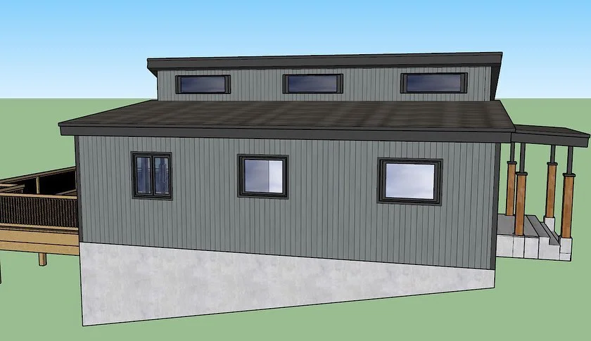 design of cottage with grey building and rear deck