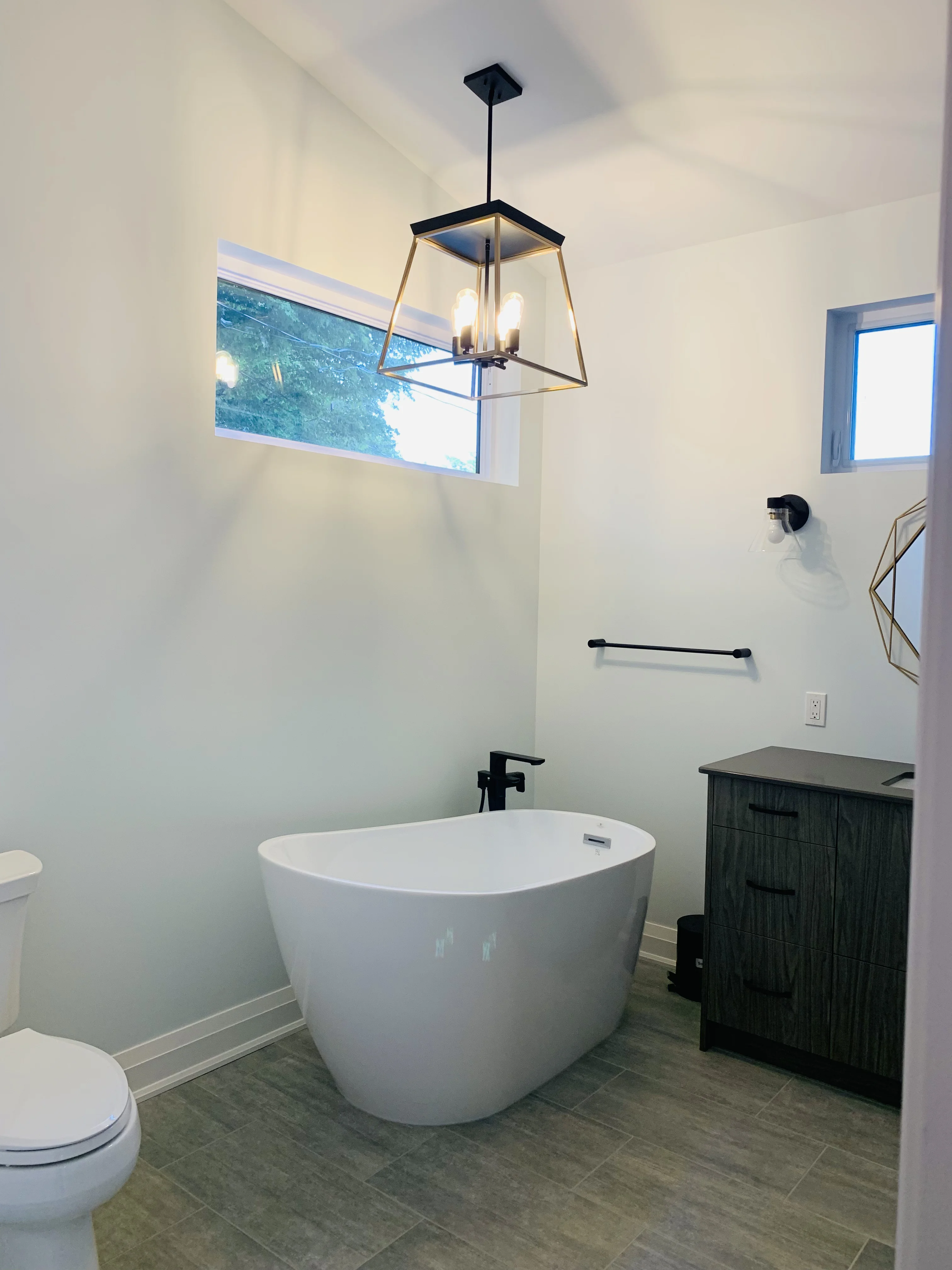 large white soaker tub beside the bathroom sink