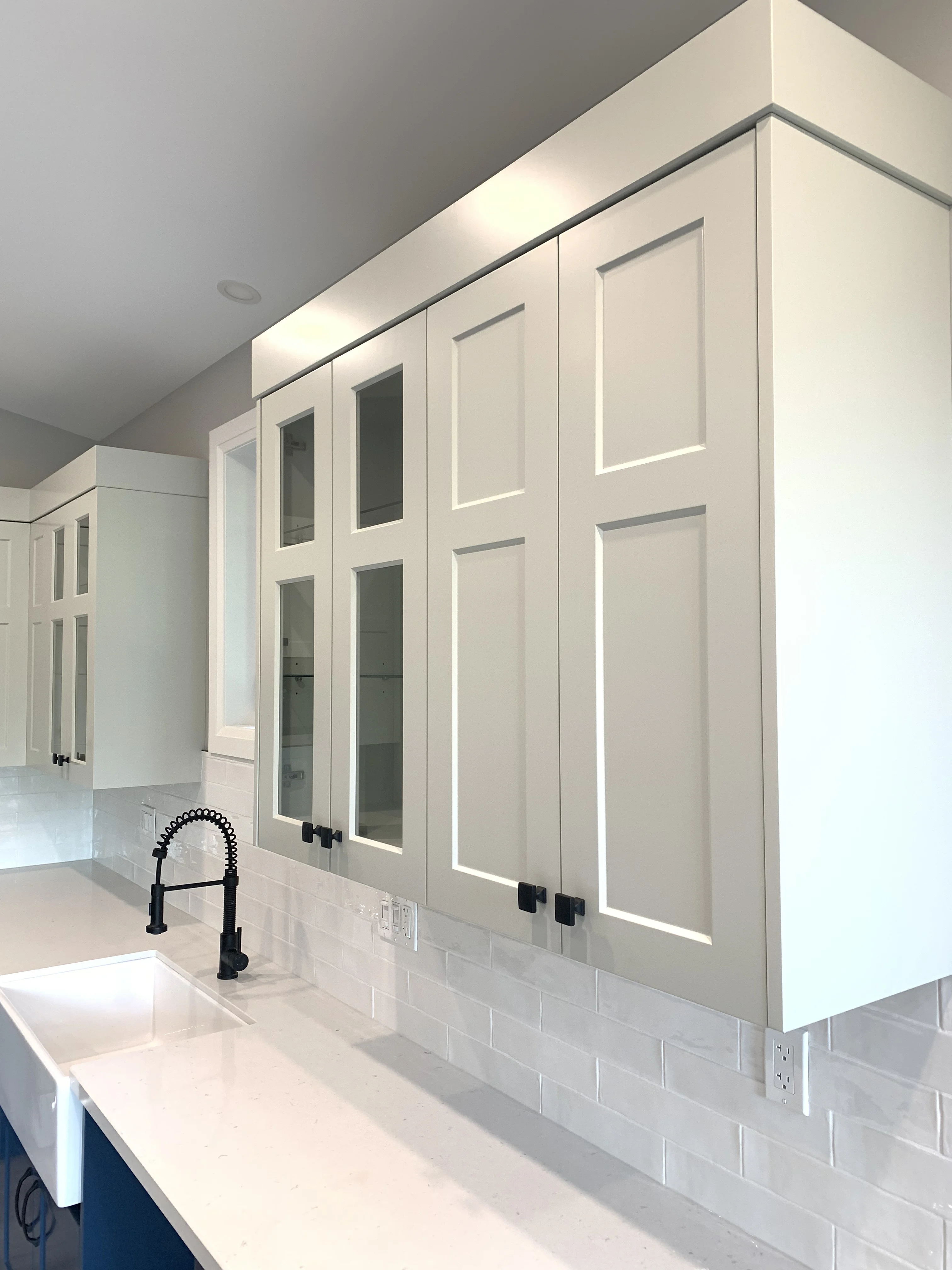white cabinets over marble kitchen counter