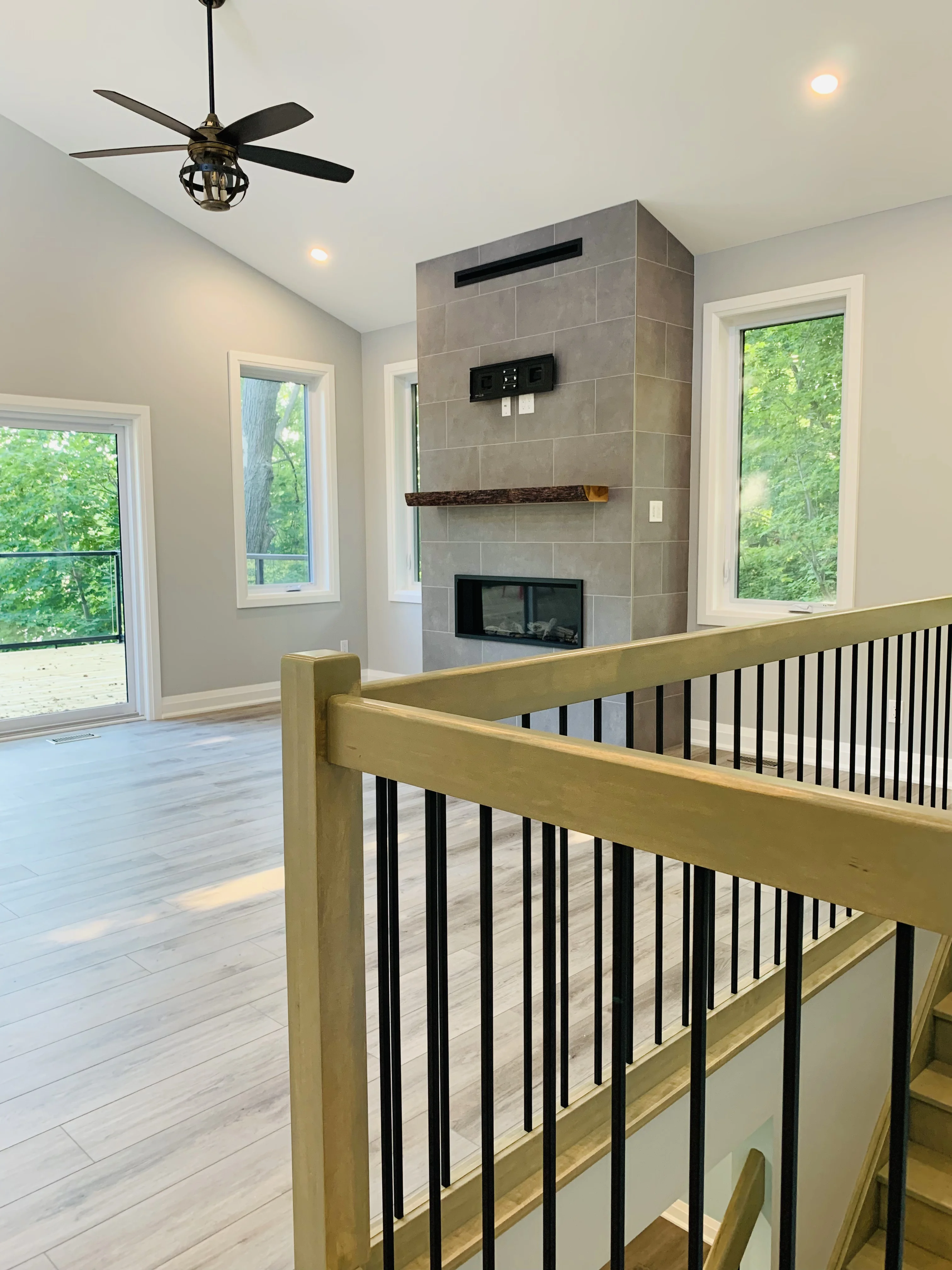 stairway view of fireplace and living space