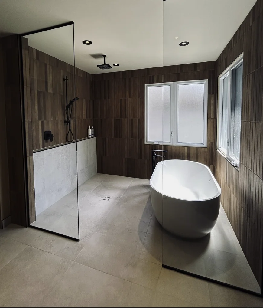 a custom bathroom stall with a tub and shower