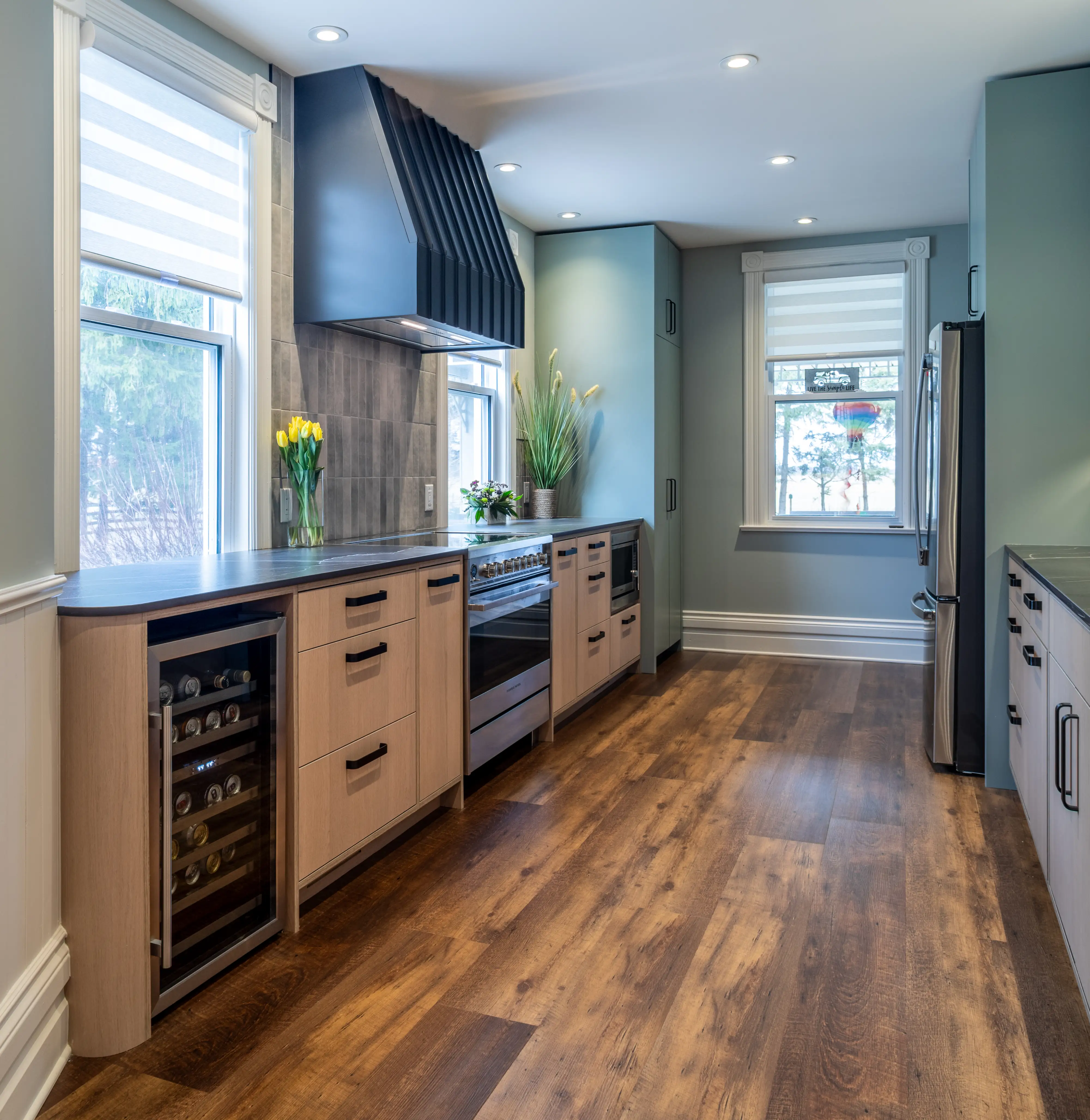 a galley kitchen with modern looks and custom counters and cabinets