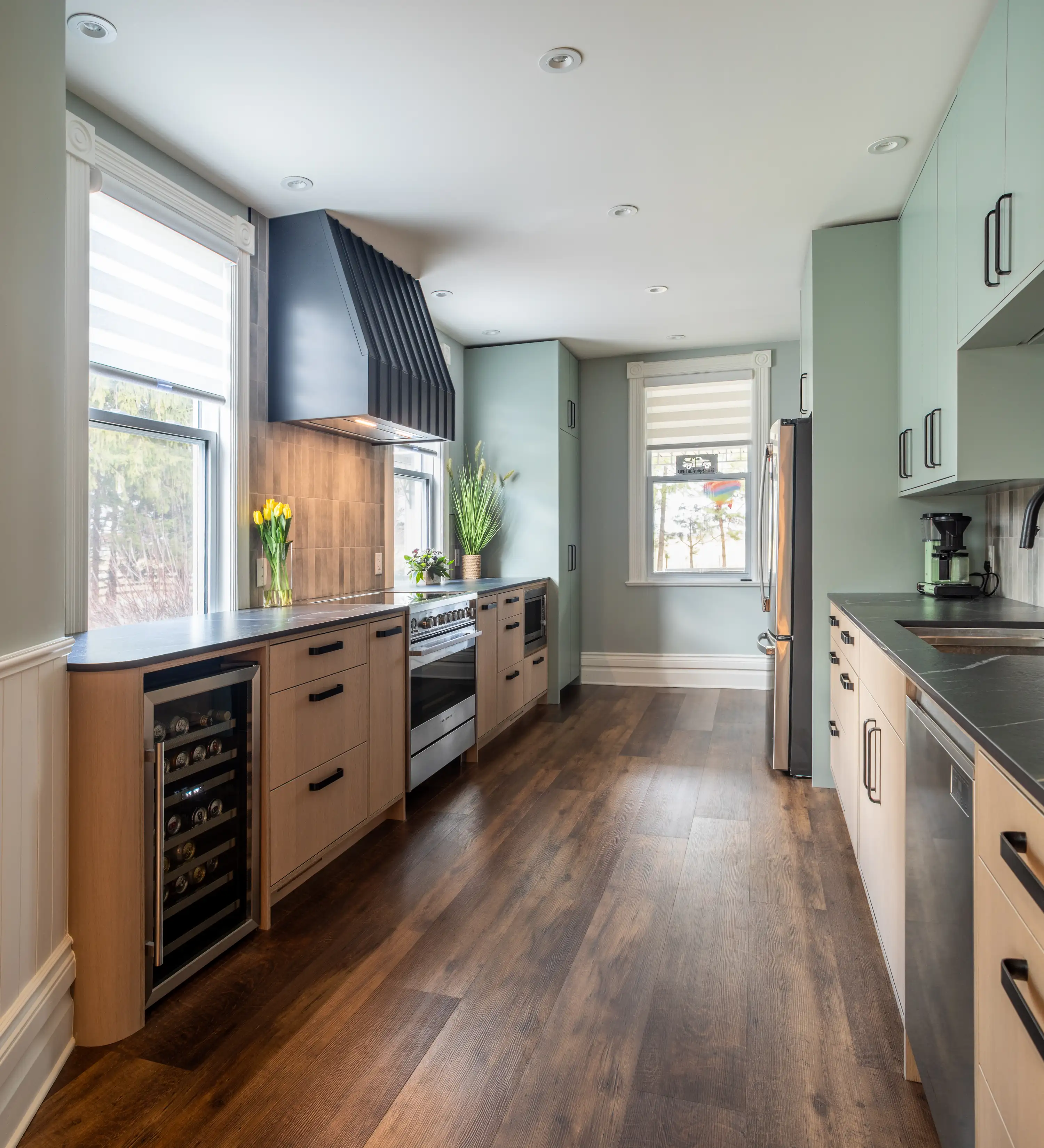 a galley kitchen modernized with new cabinets and cupboards, flooring, and appliances
