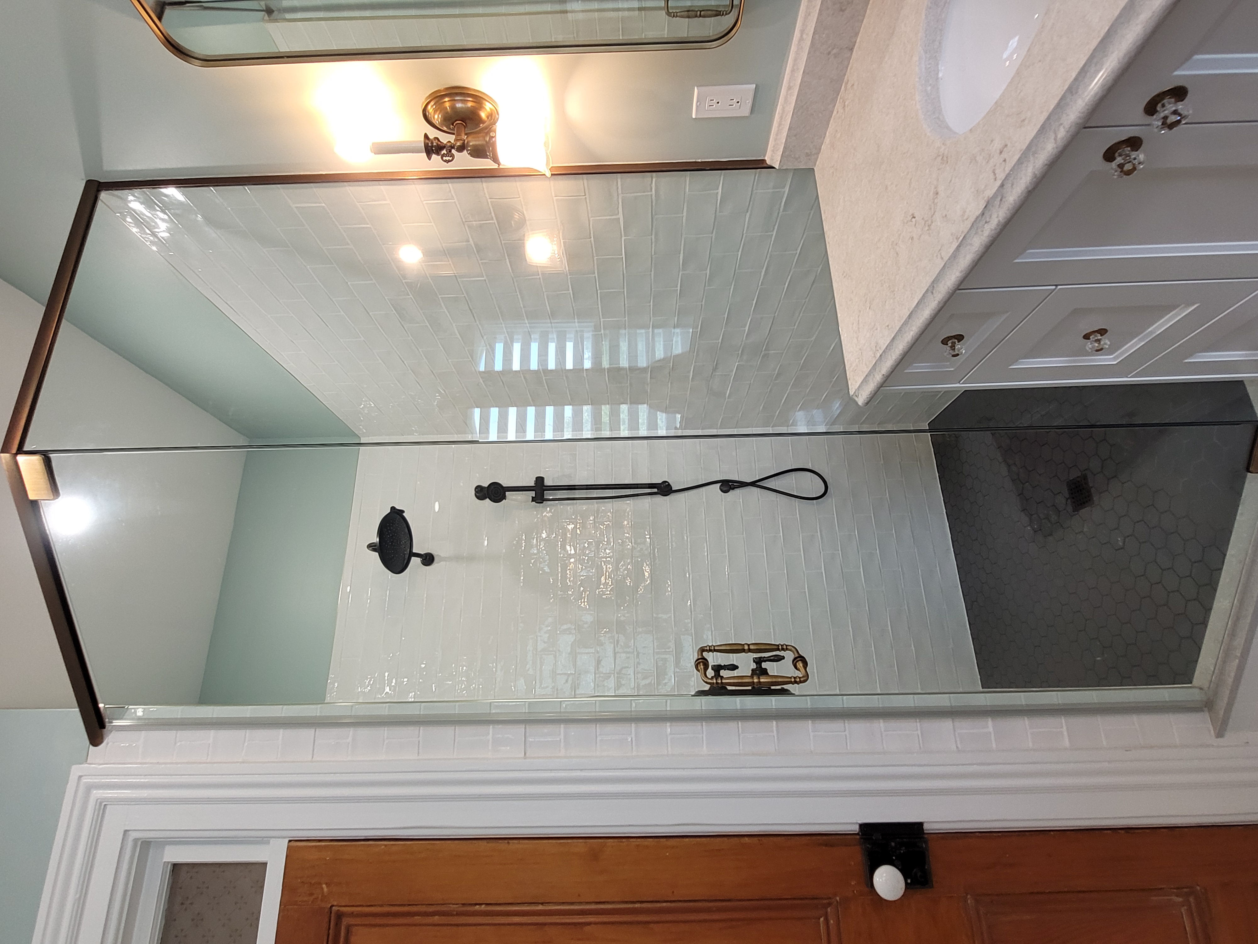 a custom bathroom stall with a tub and shower