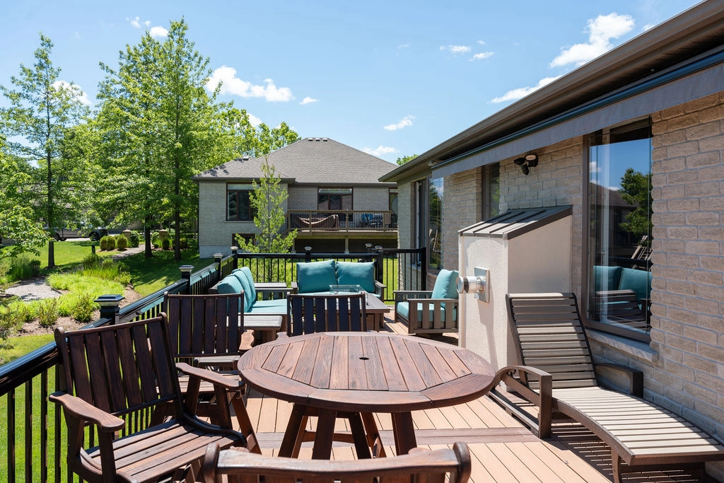 exterior of accessible home with deck, chairs, and table