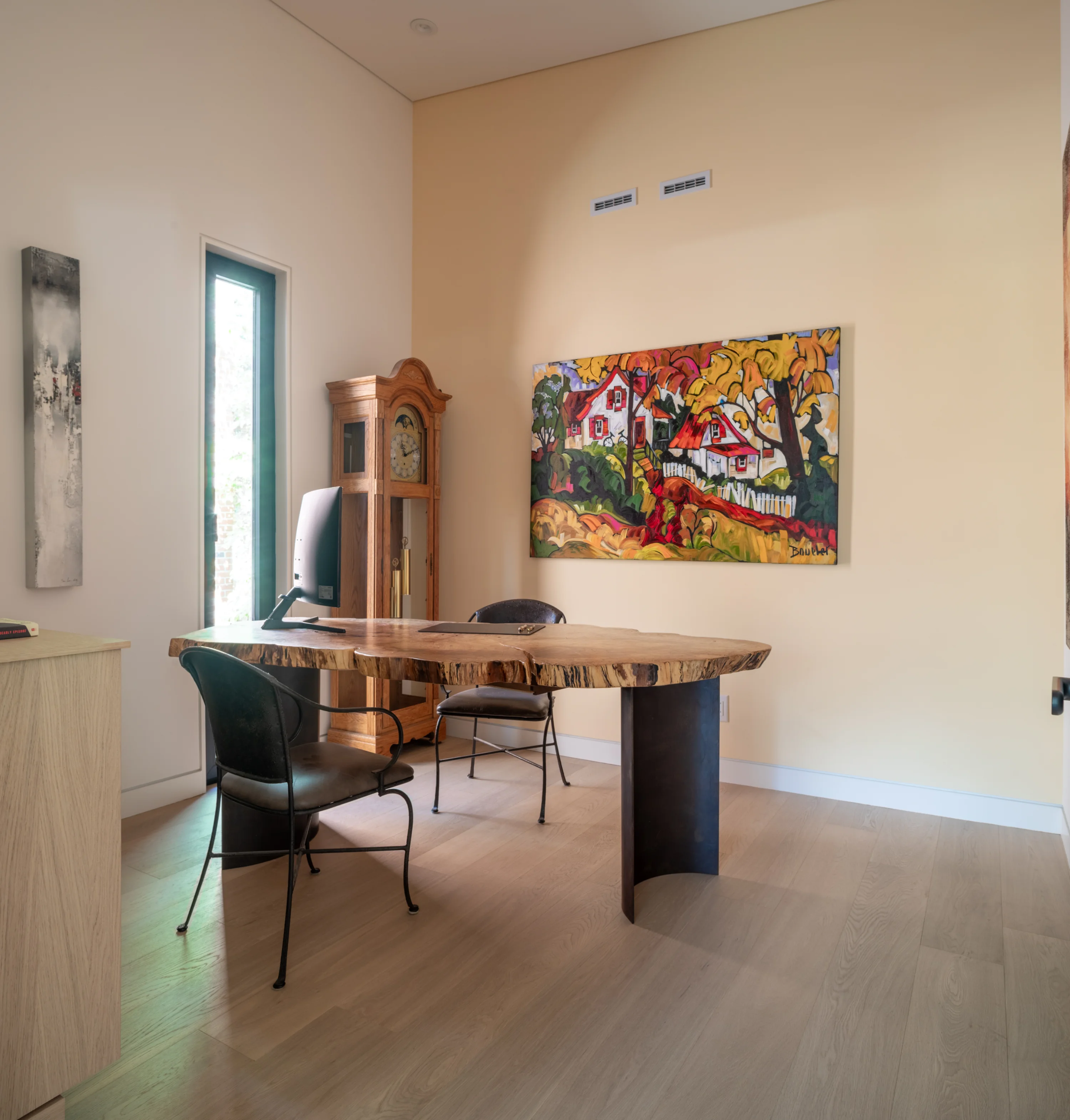 small office area with bright light and carved table