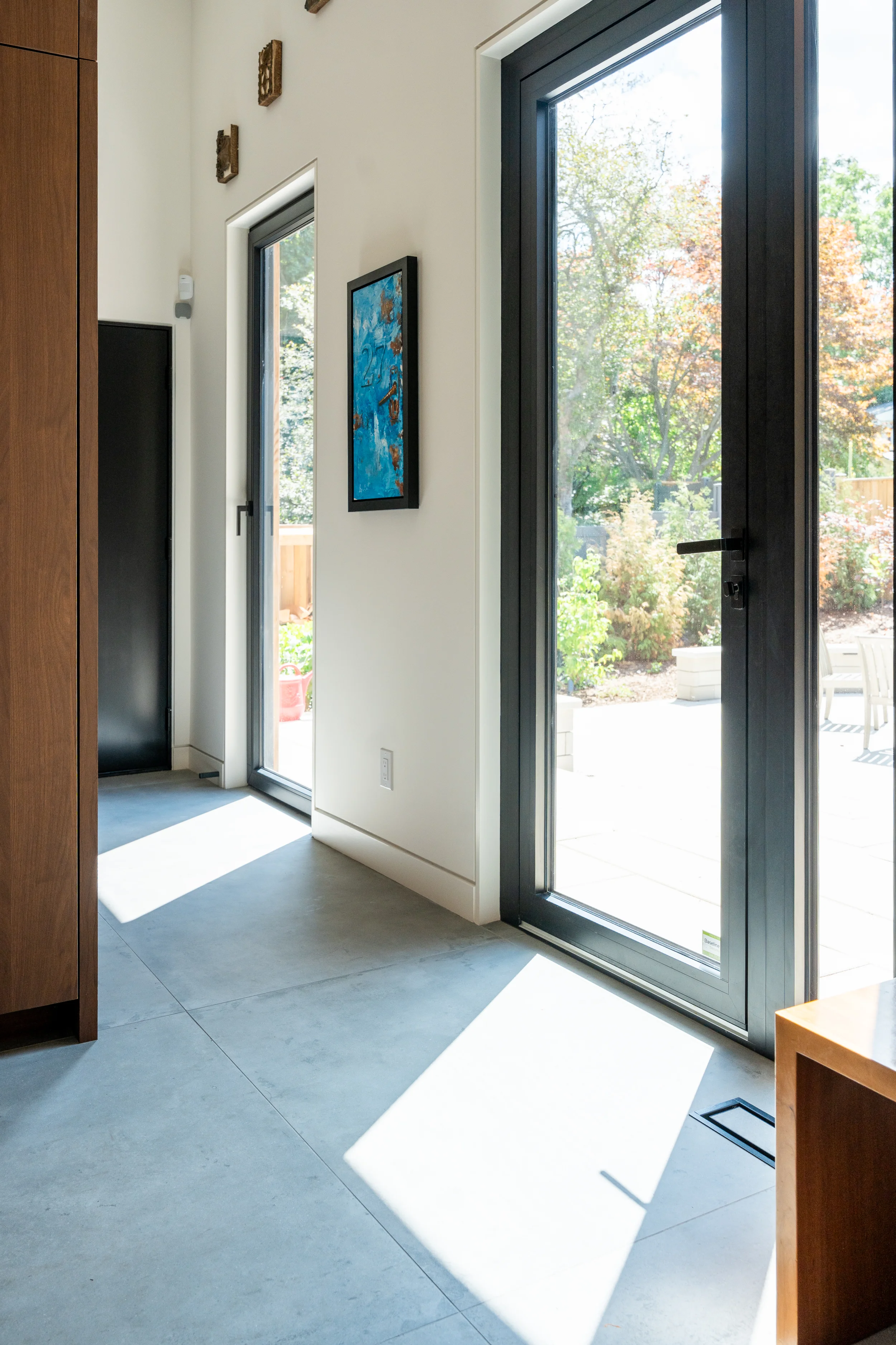 glass doors in bright sunny area looking into the hall