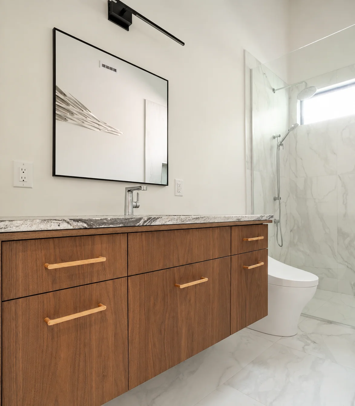 bathroom with custom cabinets, mirror, and toilet