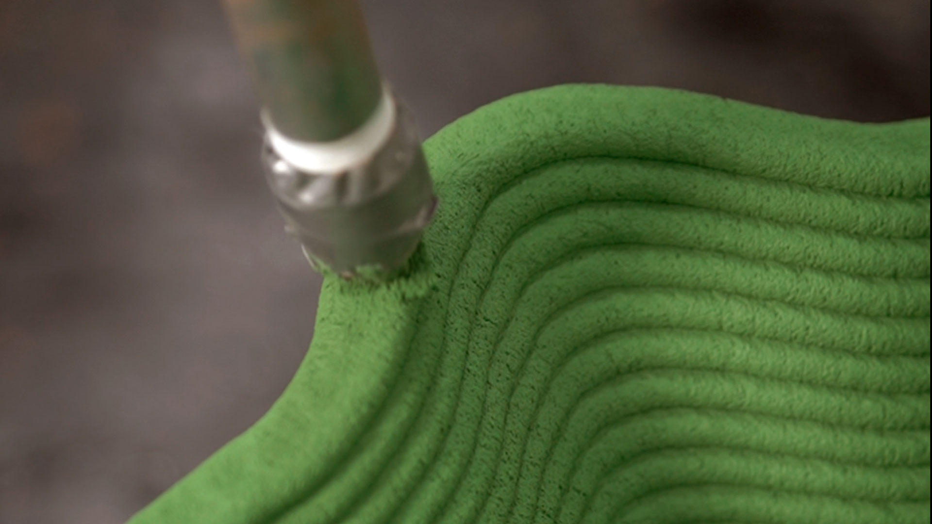 3D concrete printing machine creating layered green material surface