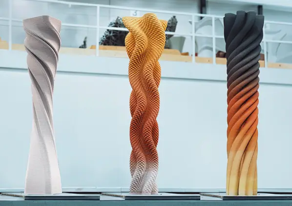 3D printed concrete columns with twisted, gradient-colored textured surfaces