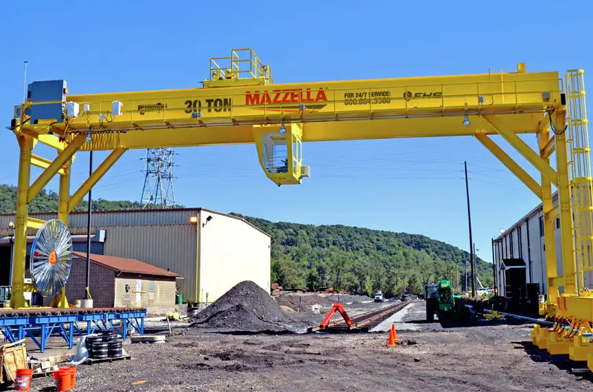 Large yellow 3D concrete printing gantry crane at industrial construction site