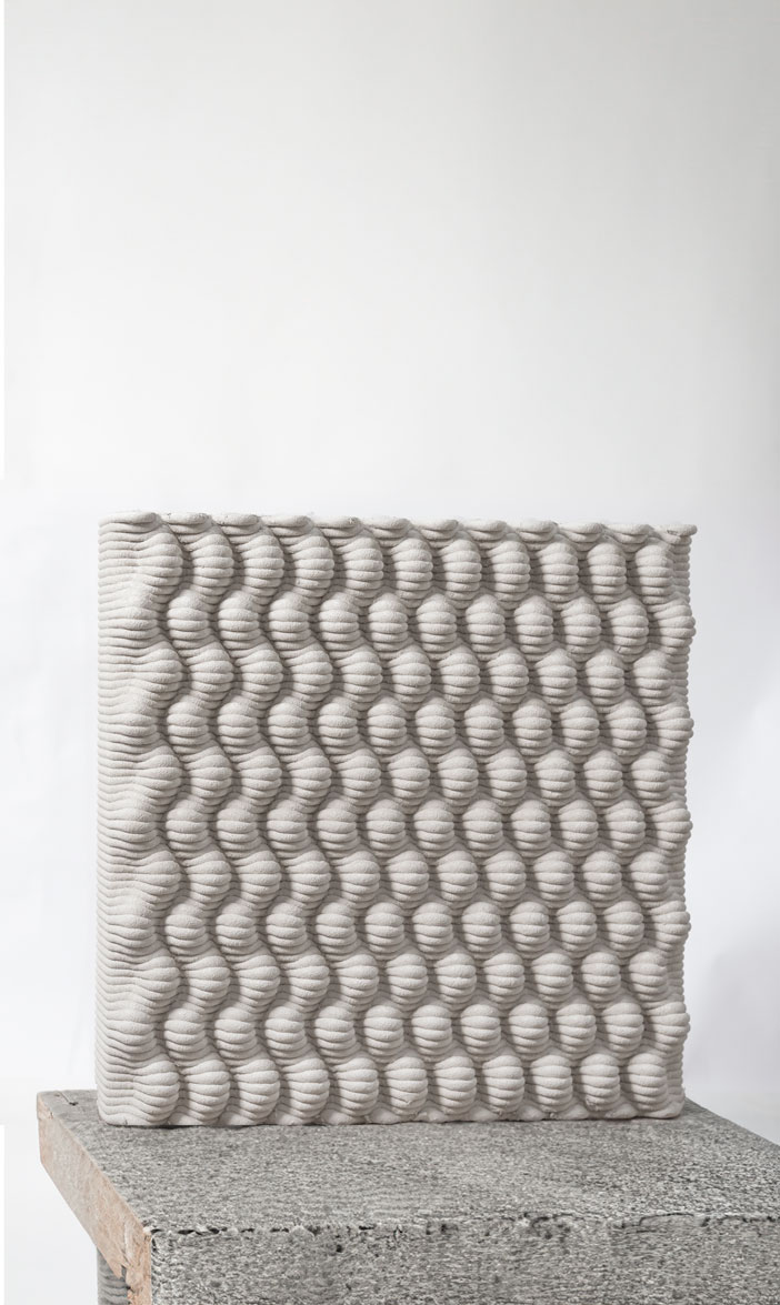 Textured concrete block with wavy patterns, showcasing innovative printing projects