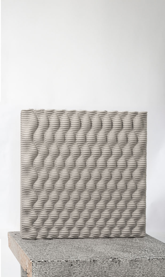 3D printed concrete block with wavy textured surface pattern