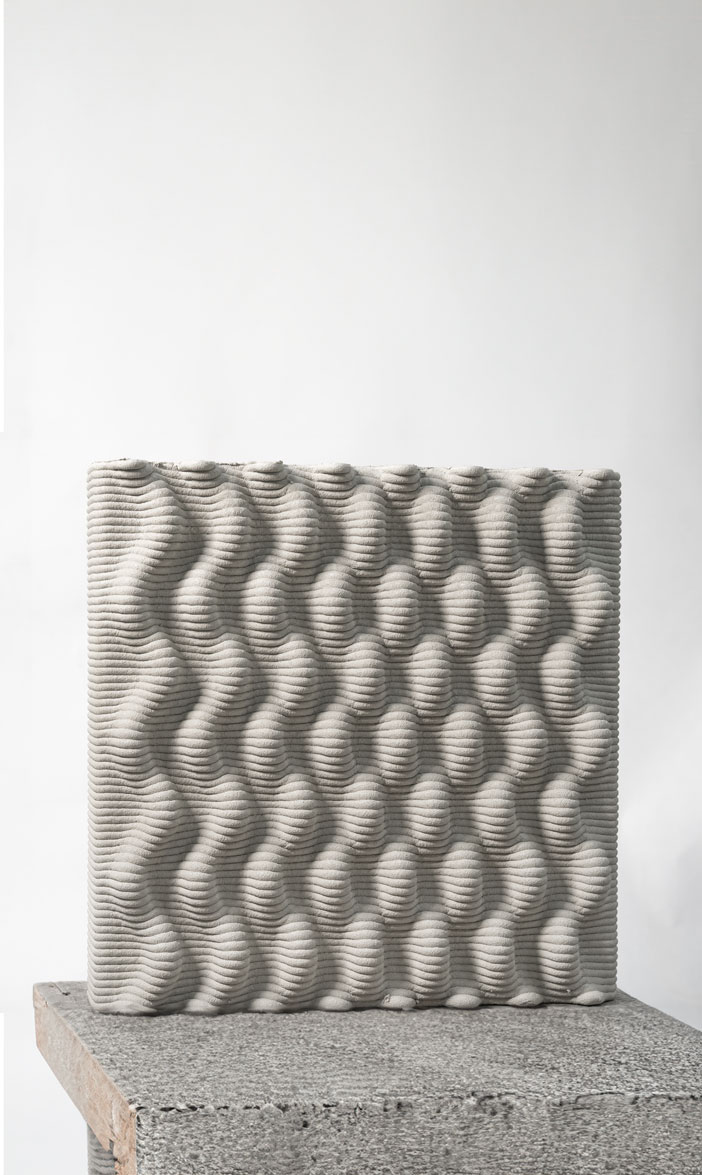 3D printed concrete block with wavy, textured surface pattern