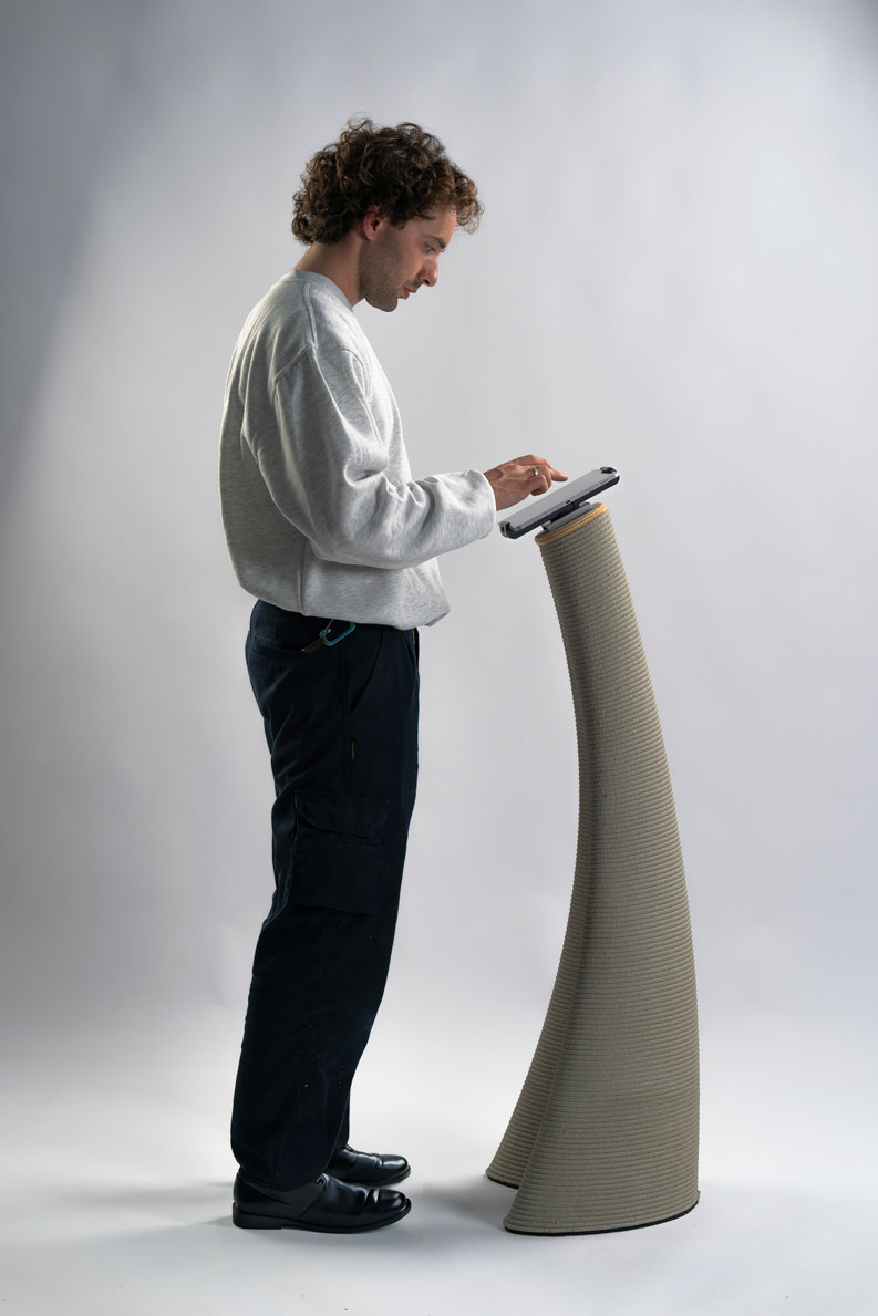 3D concrete printing device with person operating tall tapered machine