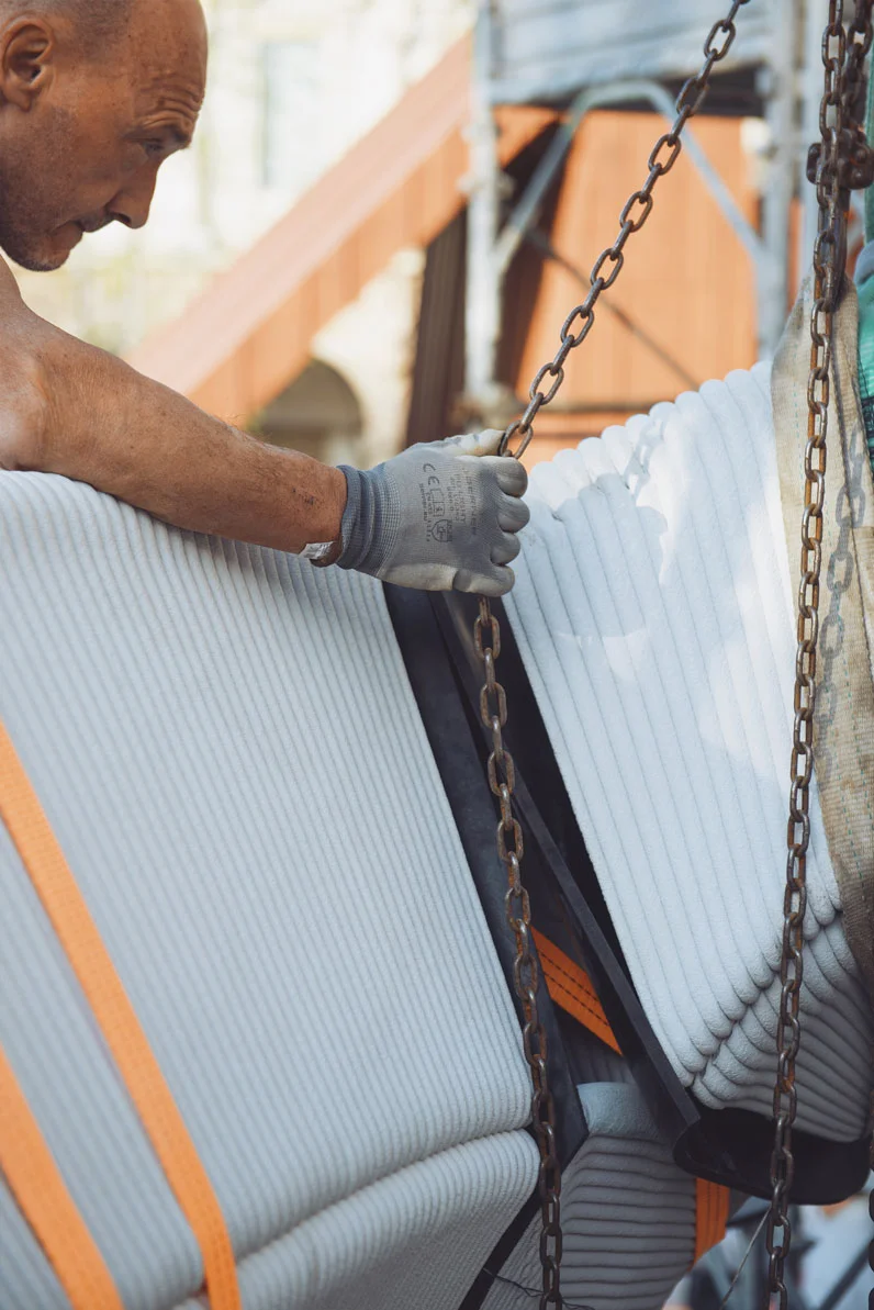 Worker handling concrete panels for printing construction projects