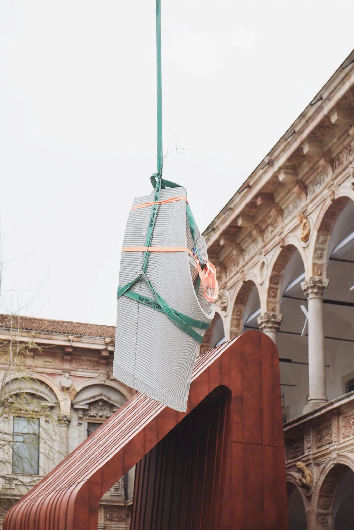 Concrete printing projects suspended between historic architectural arches