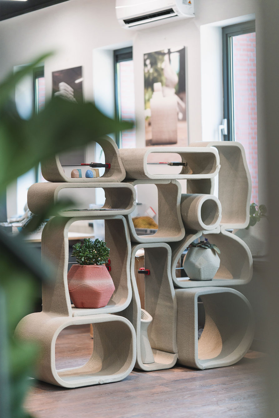 Modular concrete design shelving with curved organic shapes and potted plants