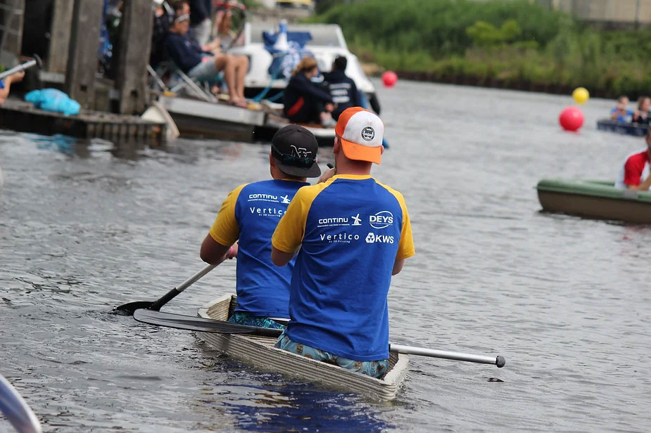 Concrete printing team rowing boat during competitive water projects event