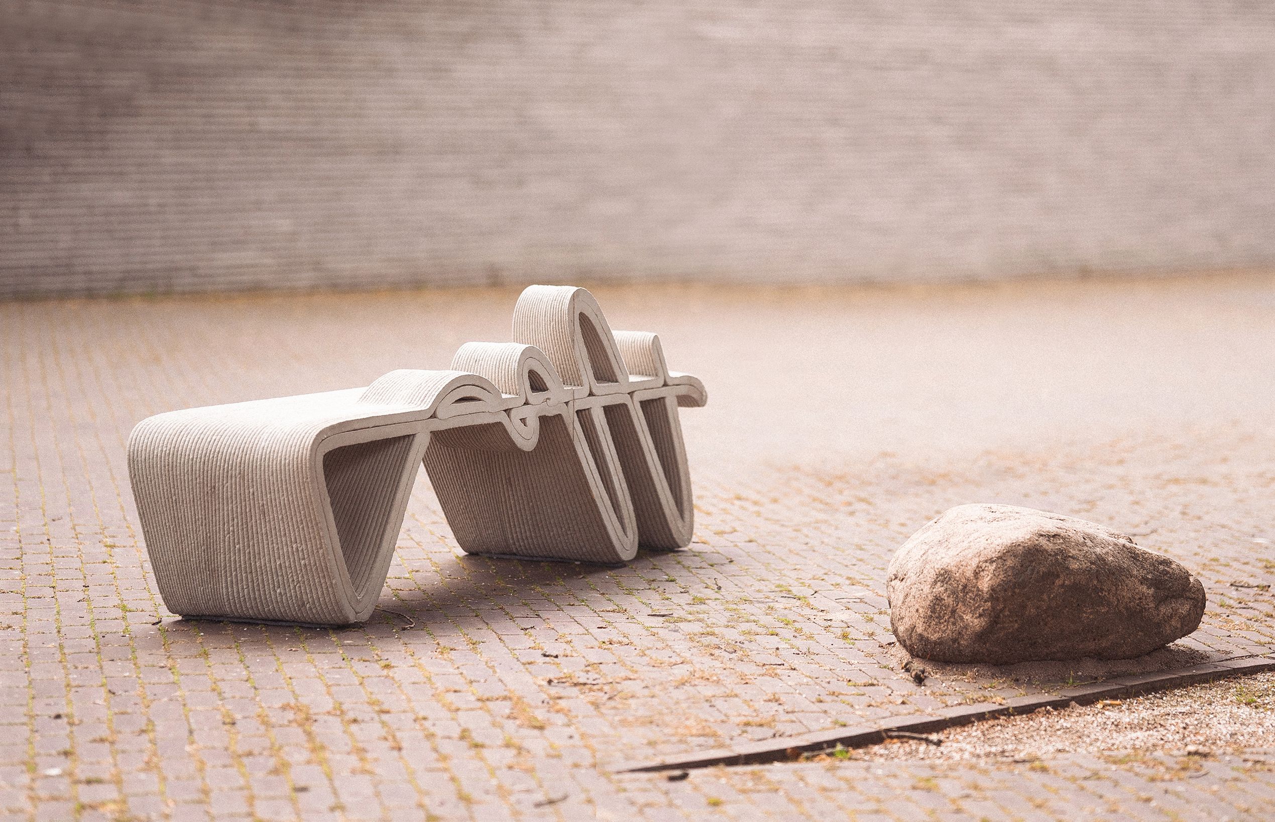 Concrete 3D printing projects with curved modular form on textured surface