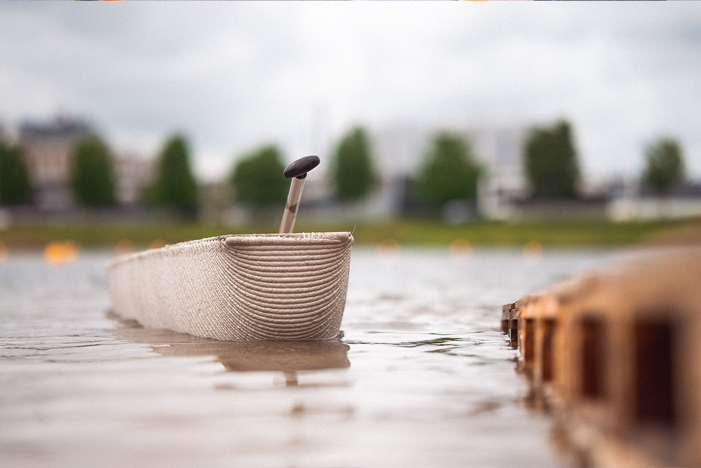 3D printed concrete boat model floating on water during architectural projects