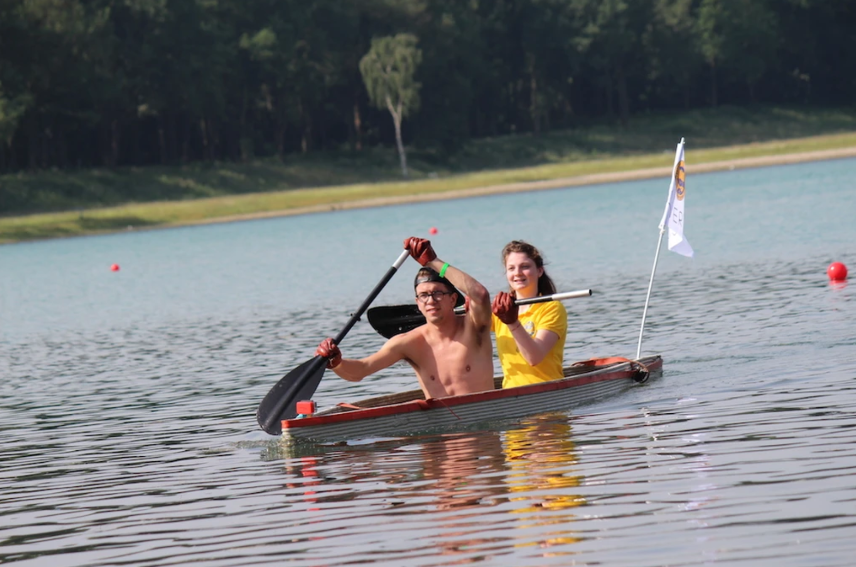 Concrete boat printing project with two people paddling on lake