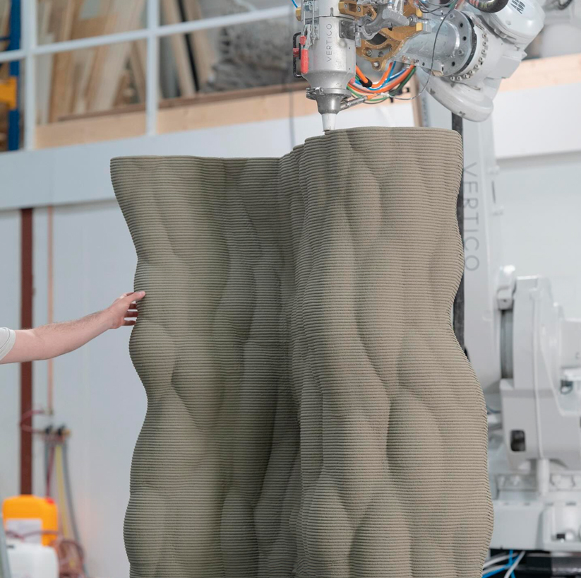 Robotic 3D printer creating large concrete structure with innovative design