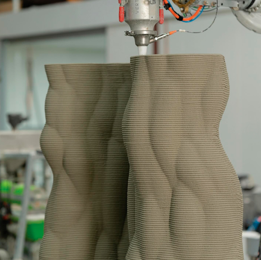 3D printer creating curved concrete design with layered extrusion technique