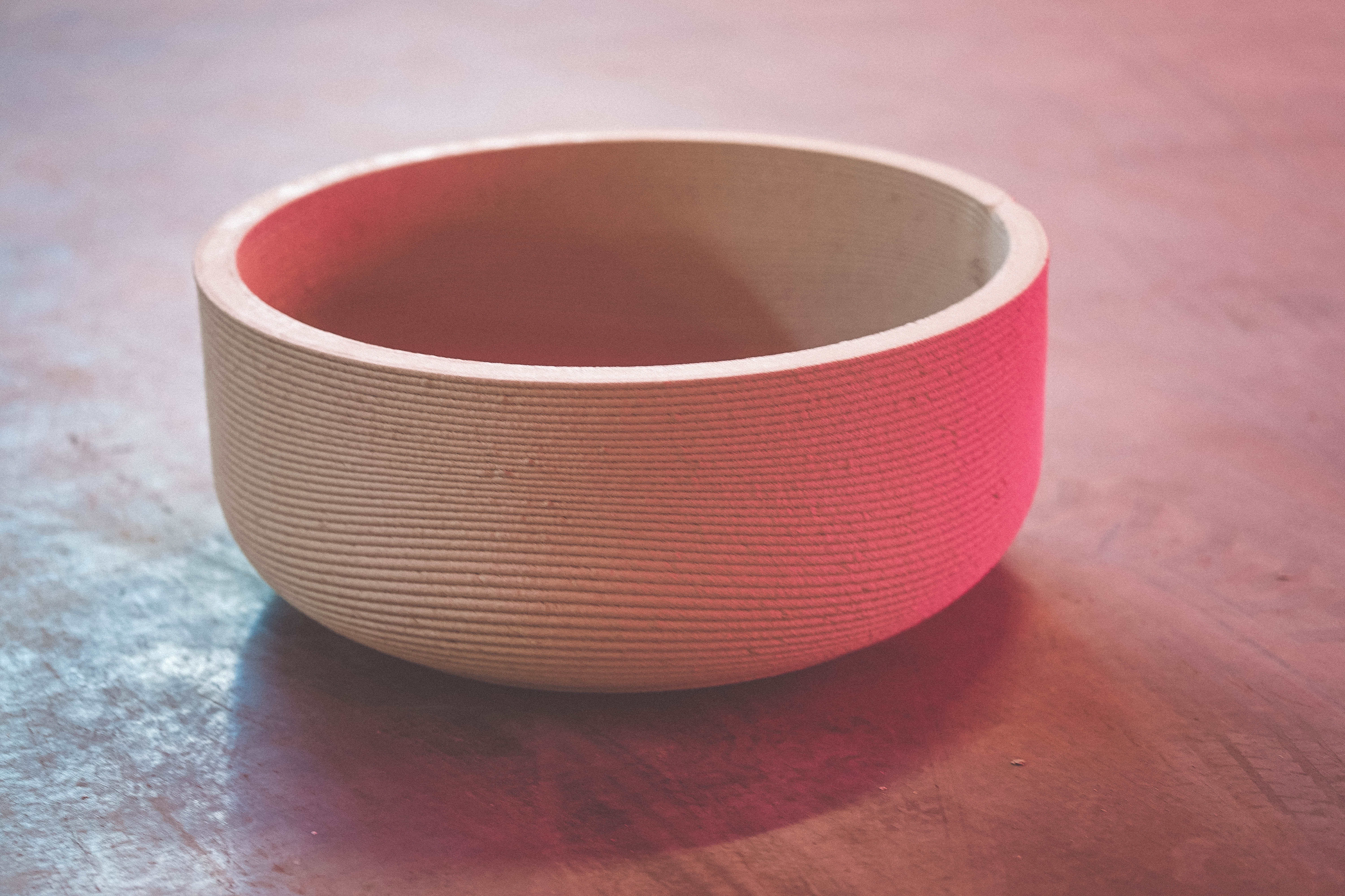 Empty ceramic bowl with gradient pink and white ribbed texture